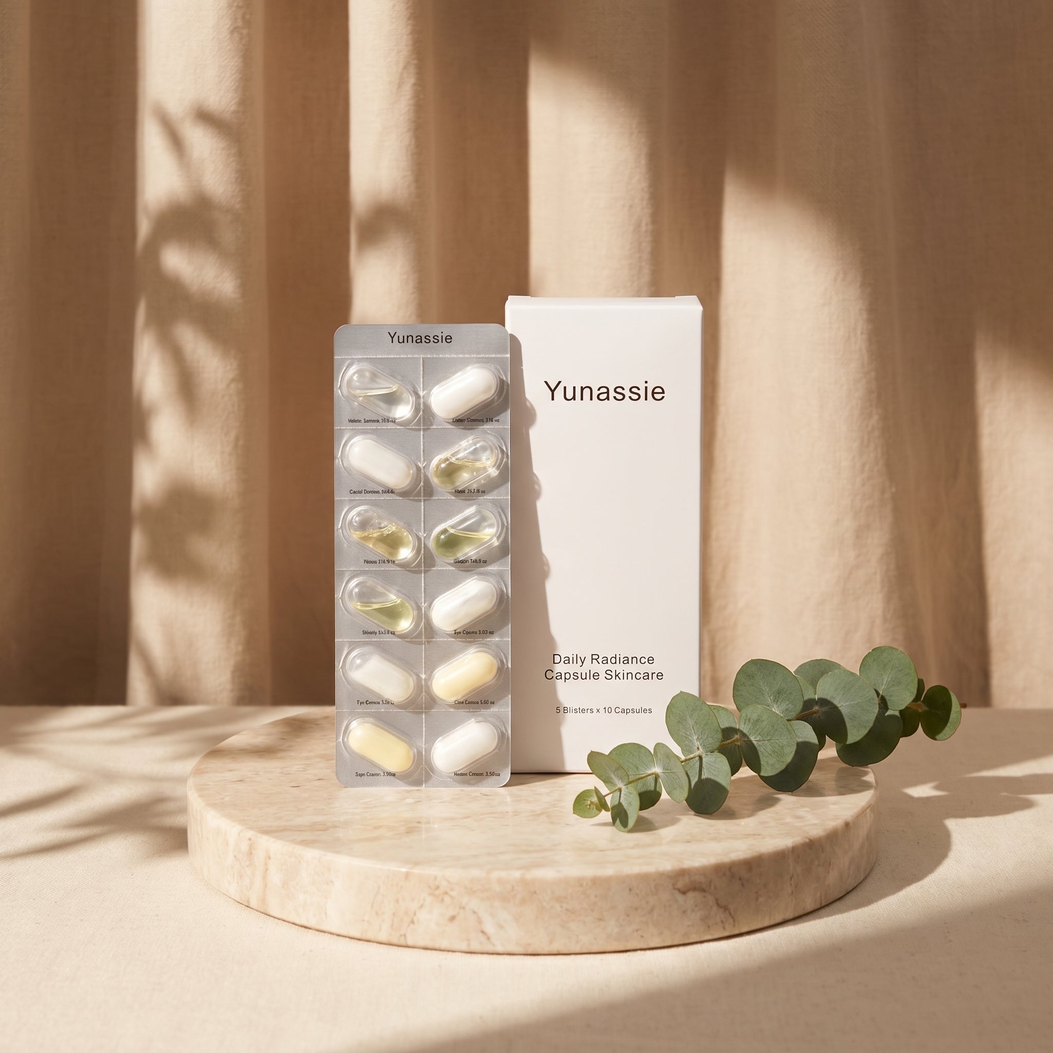Yunassie skincare capsules and packaging on a wooden stand with eucalyptus leaves.