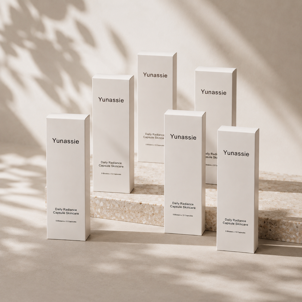 Yunassie skincare products on a neutral background with soft shadows