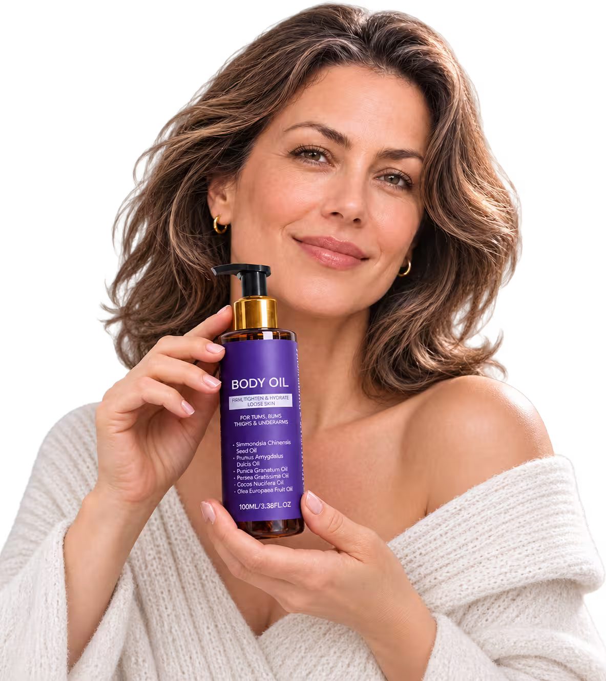 A woman with wavy brown hair wearing a white knit sweater holds a purple pump bottle of BODY OIL with a gold cap against a clean white background.