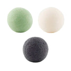 Three spherical cleaning pads in green, white, and gray on a white background